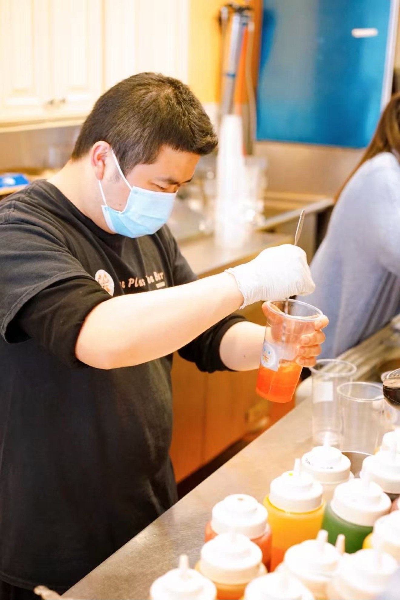 Making a drink behind the counter at Tea Plus Tea Bar